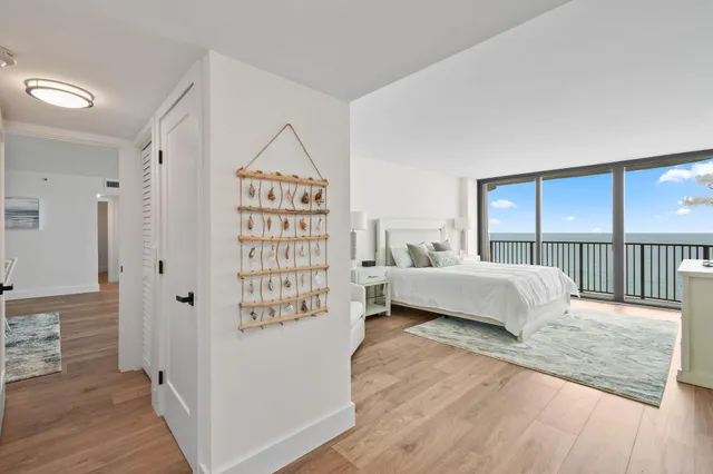 a bedroom with a large bed and a large window