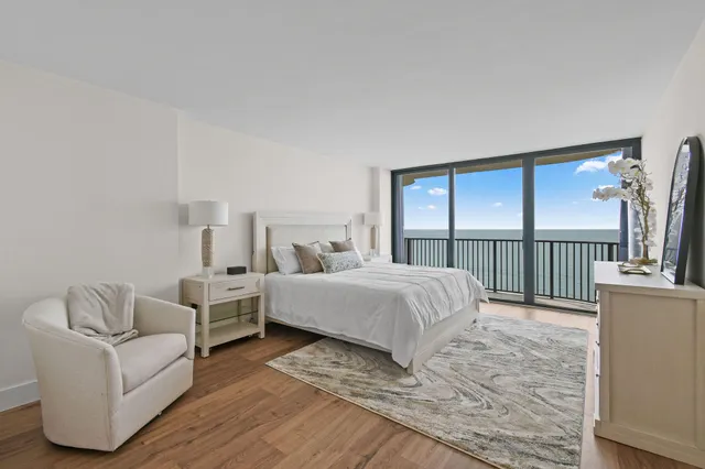 a bedroom with a bed and a large window