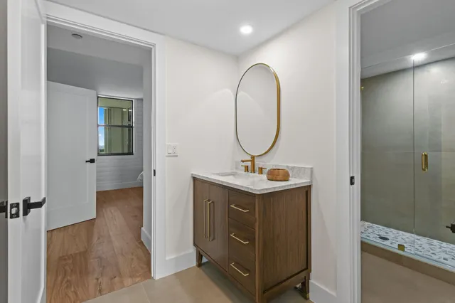 a view of a bathroom with a sink and mirror