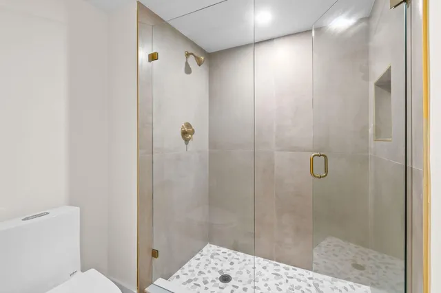 a bathroom with a shower and a toilet