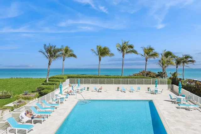 a view of a swimming pool with a yard