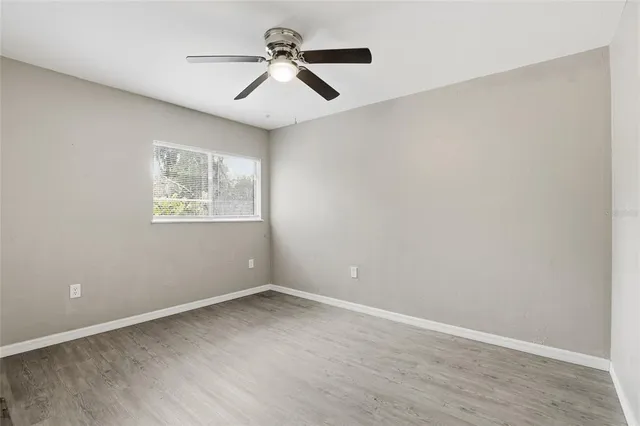a view of room with a ceiling fan and window