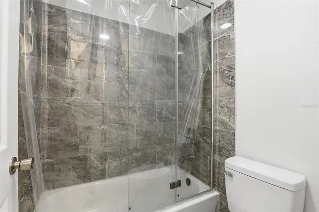 a bathroom with a shower and a toilet