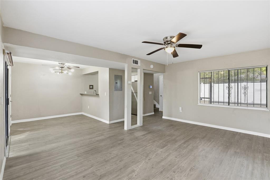 207 Southwest 6th Avenue Gainesville, FL 32601 - Photo 4 of 24 a view of empty room with wooden floor and fan