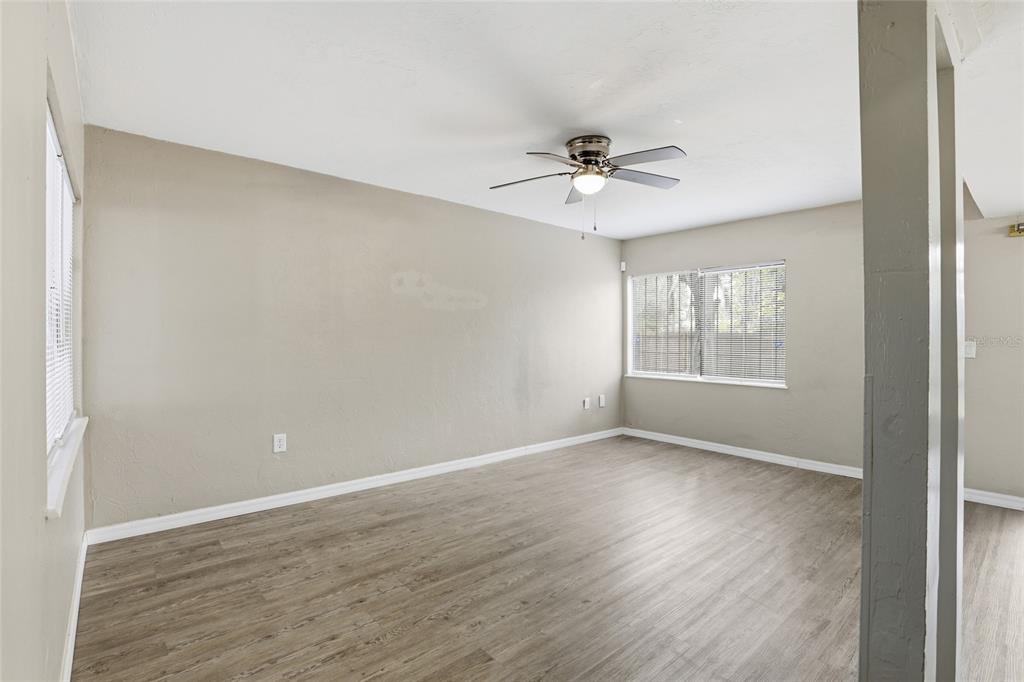 207 Southwest 6th Avenue Gainesville, FL 32601 - Photo 6 of 24 a view of empty room with wooden floor and fan
