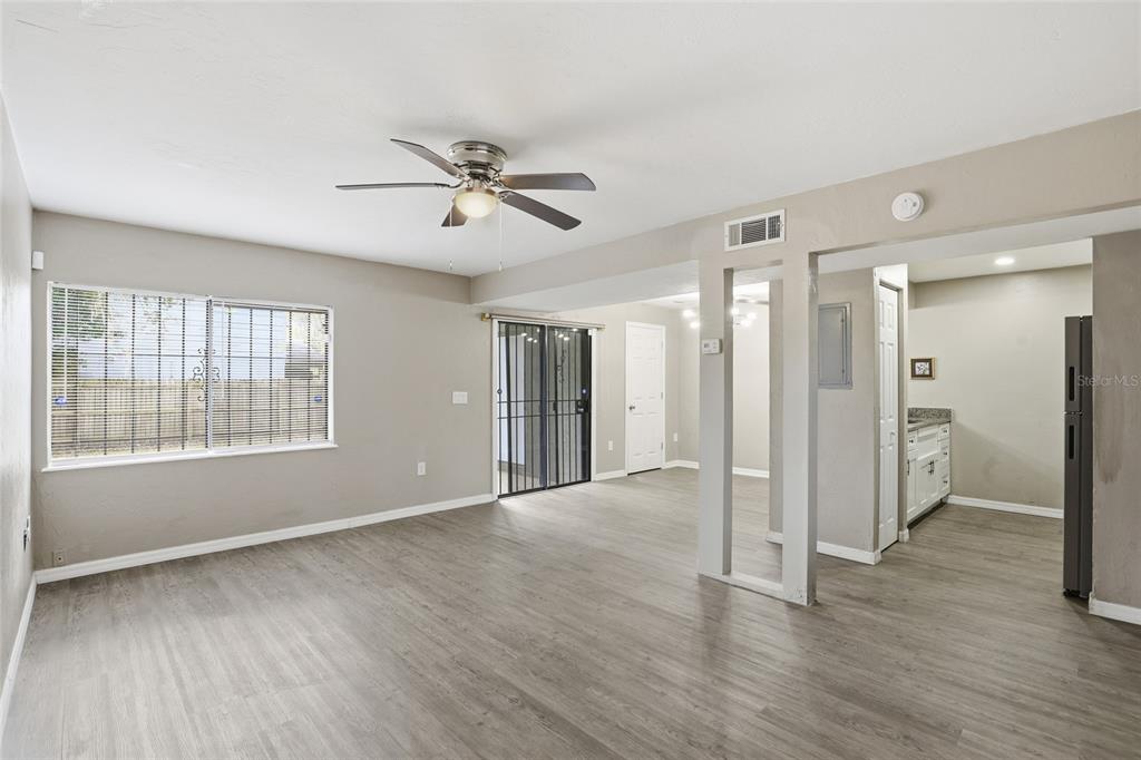 207 Southwest 6th Avenue Gainesville, FL 32601 - Photo 7 of 24 a view of empty room with wooden floor and fan