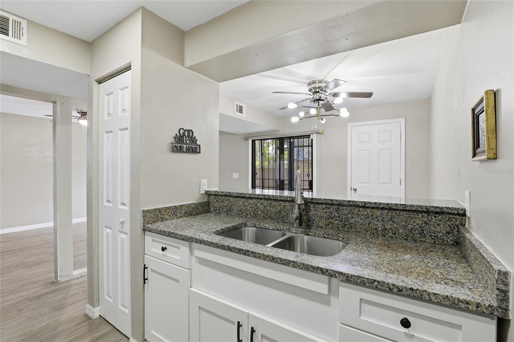 207 Southwest 6th Avenue Gainesville, FL 32601 - Photo 9 of 24 a bathroom with a granite countertop sink and a mirror