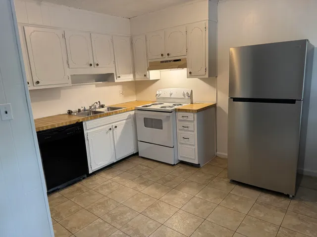 a kitchen with a sink and a refrigerator