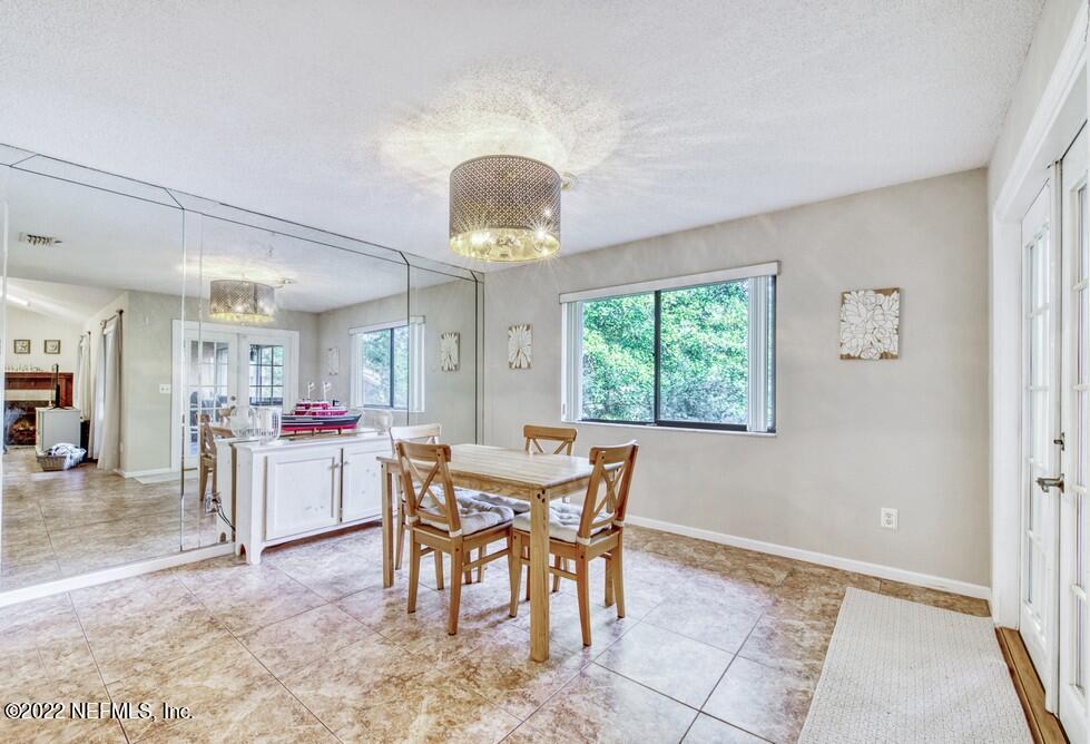 3801 Crown Point Road, Unit 3082 Jacksonville, FL 32257 - Photo 11 of 23 a view of a dining room with furniture and chandelier
