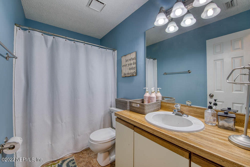 3801 Crown Point Road, Unit 3082 Jacksonville, FL 32257 - Photo 16 of 23 a bathroom with a granite countertop sink and a mirror