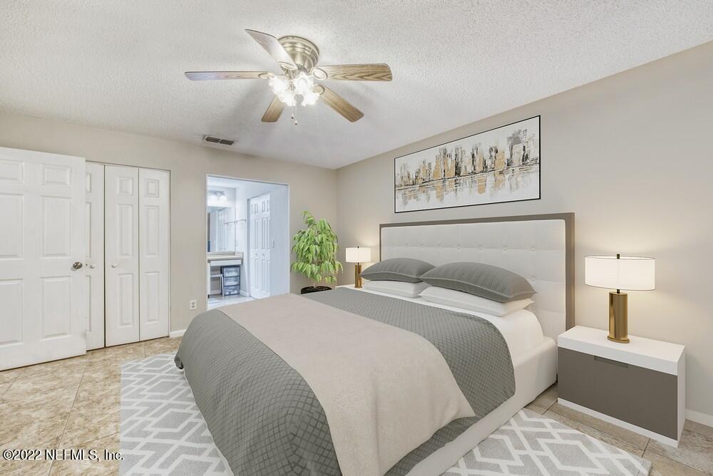 3801 Crown Point Road, Unit 3082 Jacksonville, FL 32257 - Photo 17 of 23 a bedroom with a large bed and a chandelier