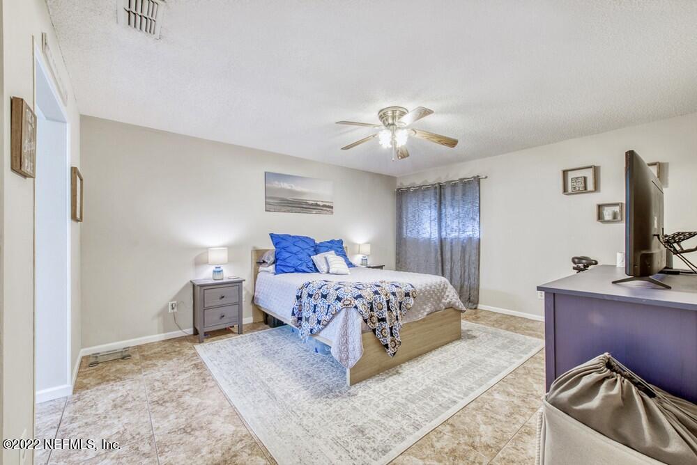 3801 Crown Point Road, Unit 3082 Jacksonville, FL 32257 - Photo 19 of 23 a bedroom with a bed and a chandelier