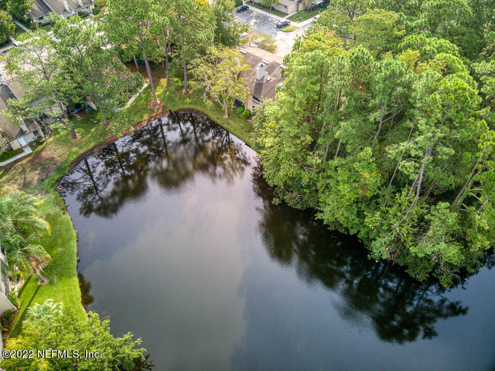 3801 Crown Point Road, Unit 3082 Jacksonville, FL 32257 - Photo 21 of 23 a view of a lake with a yard