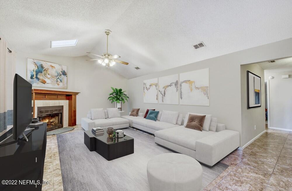 3801 Crown Point Road, Unit 3082 Jacksonville, FL 32257 - Photo 4 of 23 a living room with furniture and a fireplace