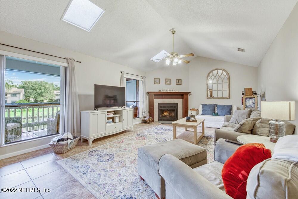 3801 Crown Point Road, Unit 3082 Jacksonville, FL 32257 - Photo 5 of 23 a living room with furniture a fireplace and a flat screen tv
