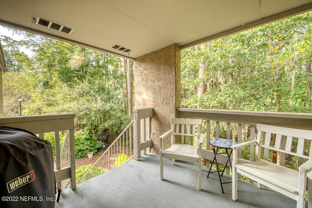 3801 Crown Point Road, Unit 3082 Jacksonville, FL 32257 - Photo 8 of 23 a balcony with furniture and a window
