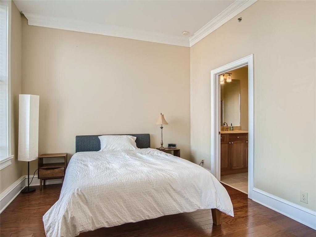 57 Forsyth Street Northwest, Unit 9C Atlanta, GA 30303 - Photo 4 of 11 a bedroom with a bed and a table