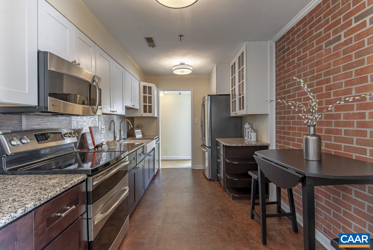 4 Marina Point Palmyra, VA 22963 - Photo 18 of 51 a kitchen with stainless steel appliances granite countertop a stove top oven a sink a dining table and chairs
