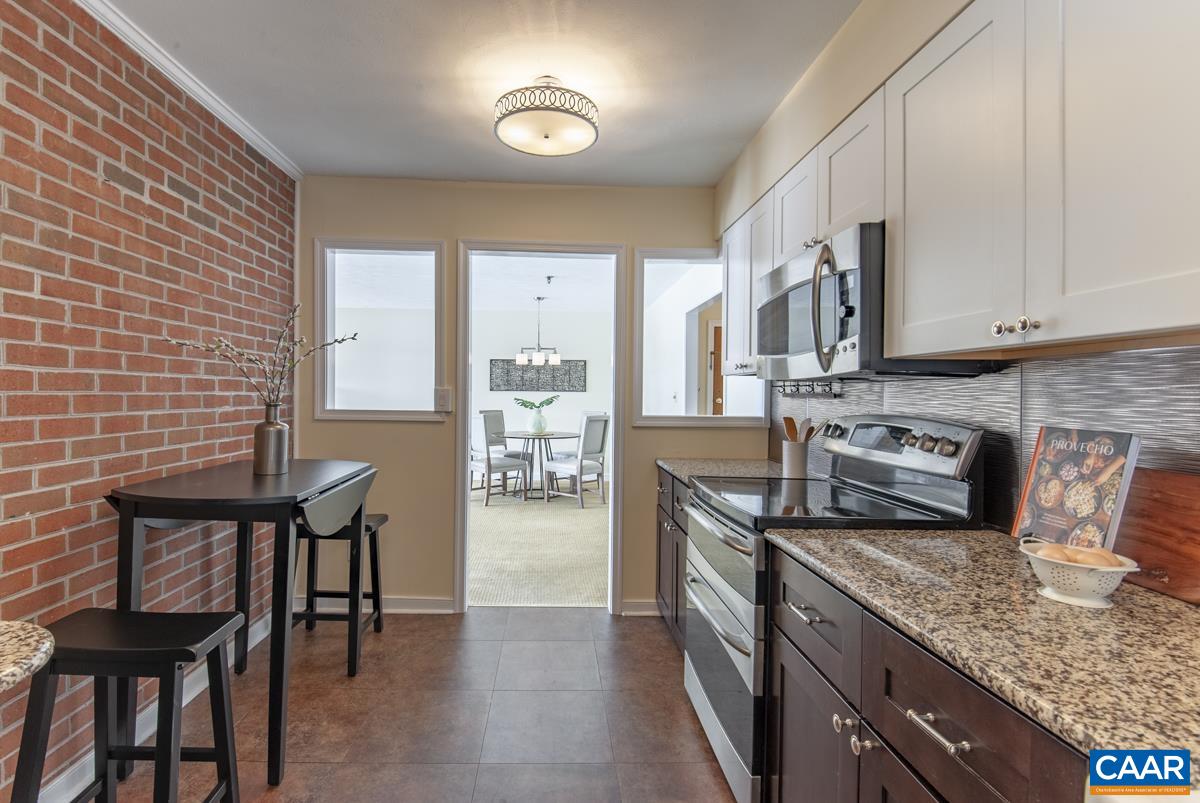 4 Marina Point Palmyra, VA 22963 - Photo 19 of 51 a kitchen with stainless steel appliances granite countertop a stove top oven a sink a dining table and chairs
