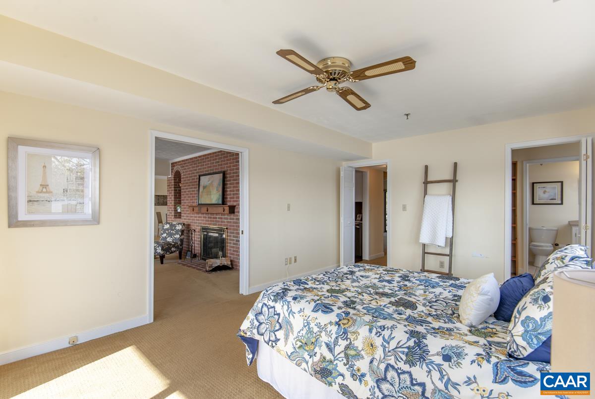 4 Marina Point Palmyra, VA 22963 - Photo 26 of 51 a bedroom with a bed and a chandelier