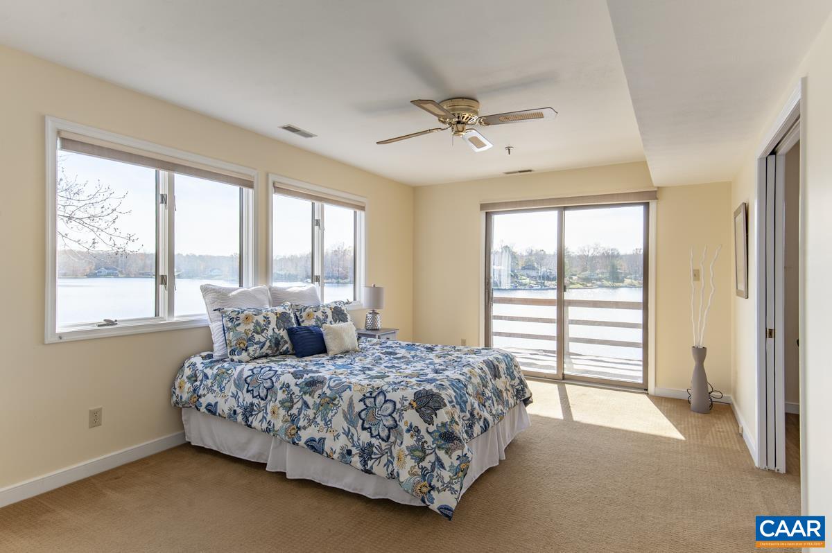 4 Marina Point Palmyra, VA 22963 - Photo 27 of 51 a bedroom with a large bed and a large window