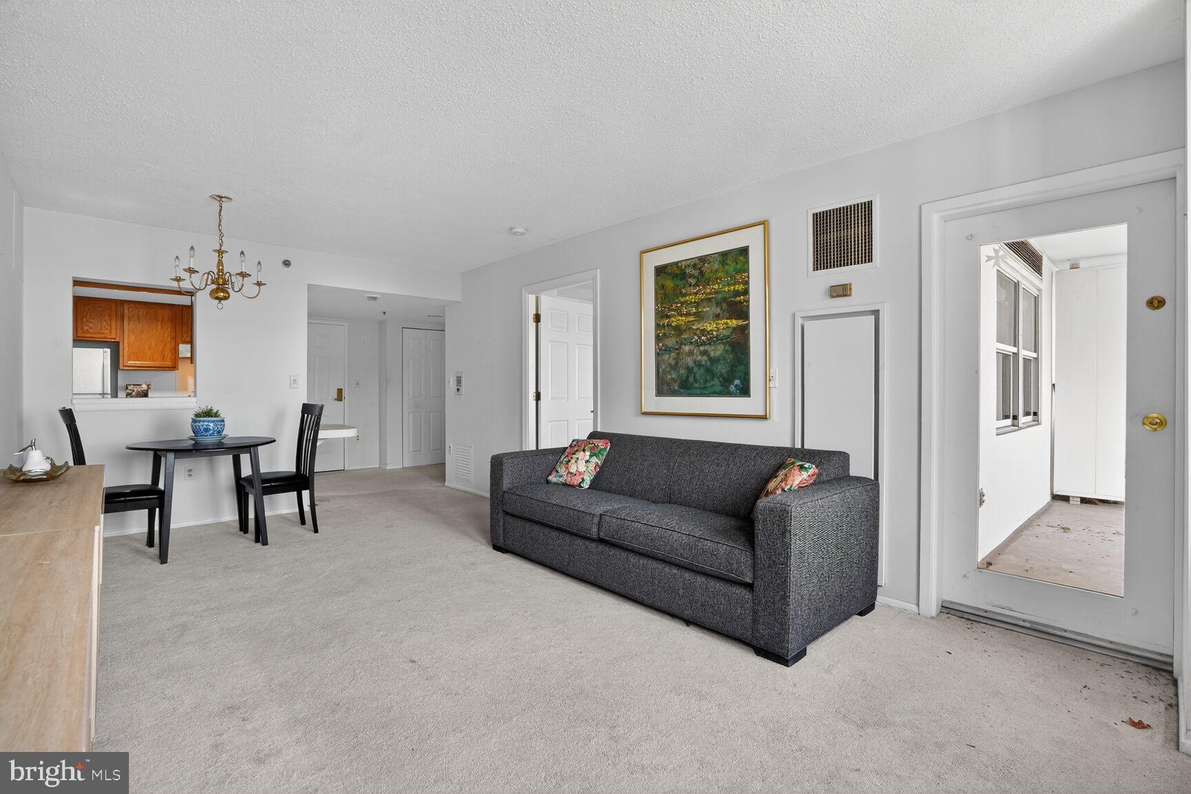 900 North Taylor Street, Unit 909 Arlington, VA 22203 - Photo 11 of 42 a living room with furniture and a dining table
