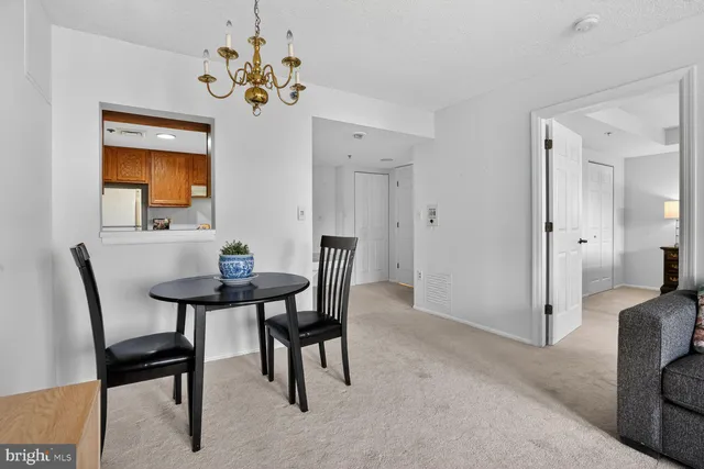 a view of a dining room with furniture and a chandelier