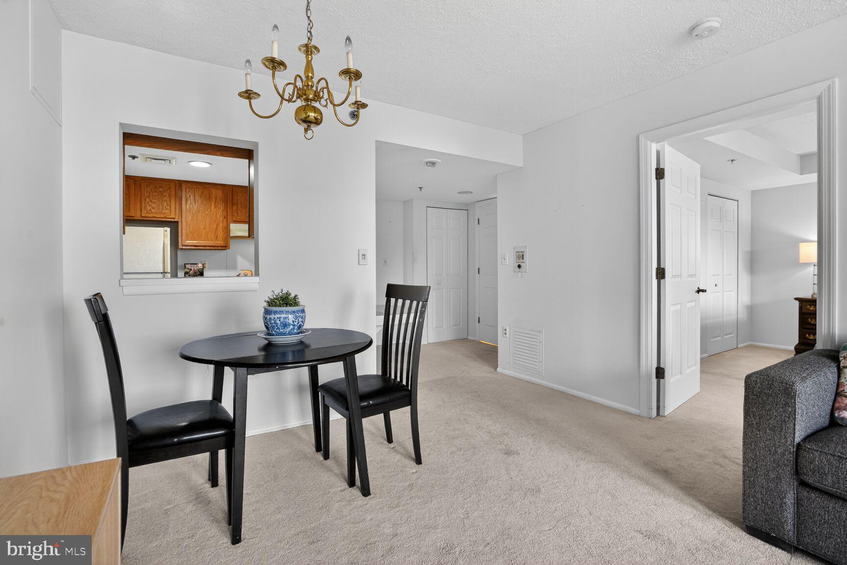900 North Taylor Street, Unit 909 Arlington, VA 22203 - Photo 12 of 42 a view of a dining room with furniture and a chandelier