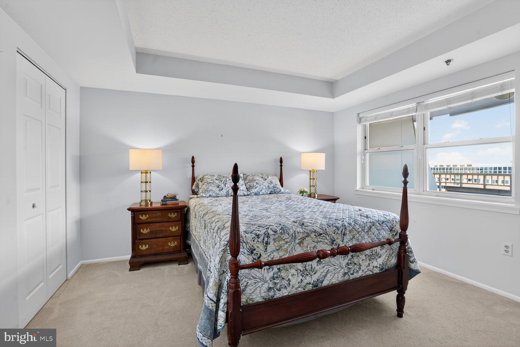 900 North Taylor Street, Unit 909 Arlington, VA 22203 - Photo 14 of 42 a bedroom with a bed and a table