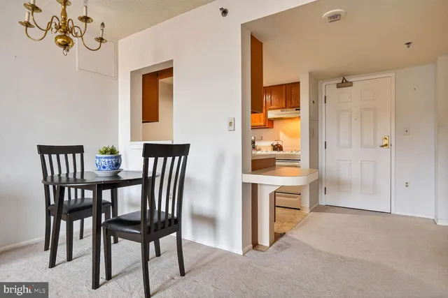 a view of a dining room with furniture and window