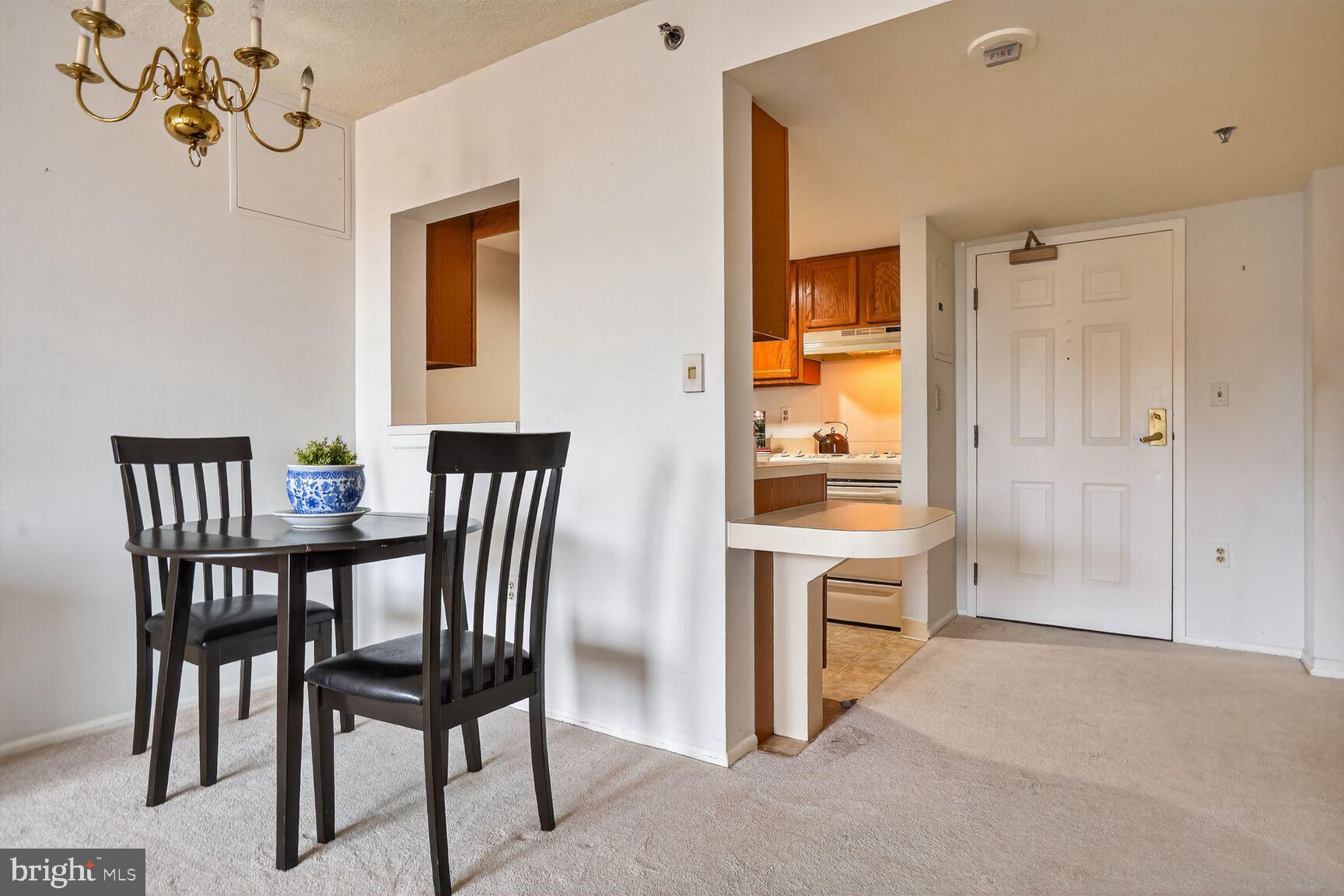 900 North Taylor Street, Unit 909 Arlington, VA 22203 - Photo 5 of 42 a view of a dining room with furniture and window