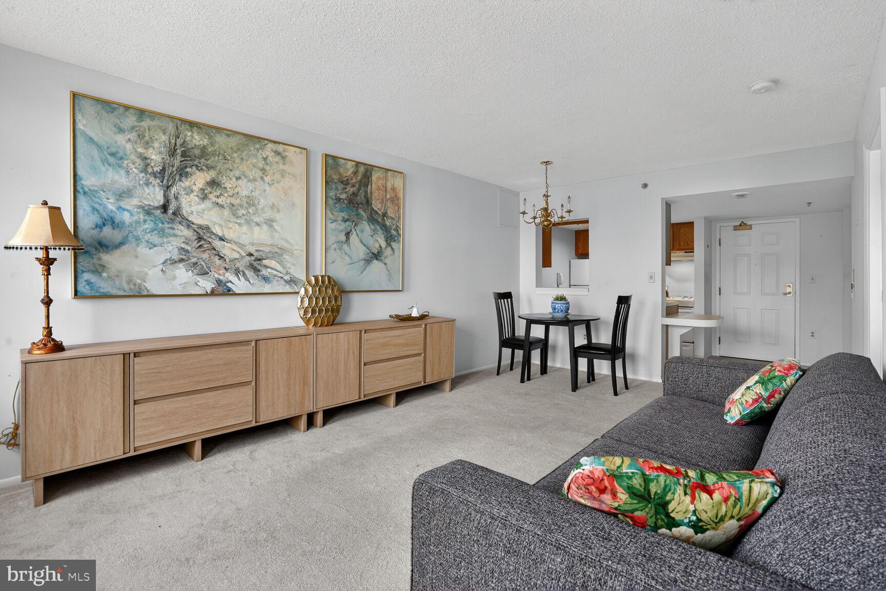 900 North Taylor Street, Unit 909 Arlington, VA 22203 - Photo 9 of 42 a living room with furniture and wooden floor