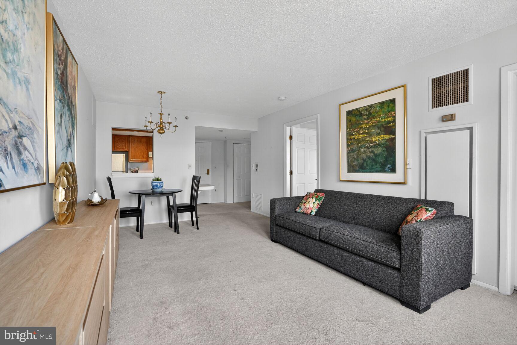 900 North Taylor Street, Unit 909 Arlington, VA 22203 - Photo 10 of 42 a living room with furniture and a window