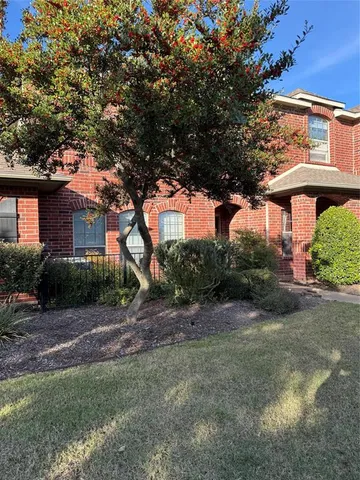 a view of a house with a tree in a yard