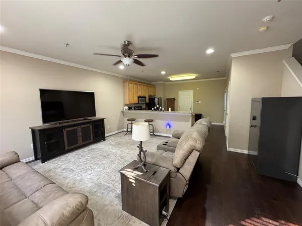 a kitchen with stainless steel appliances granite countertop a stove a sink dishwasher a refrigerator and a microwave