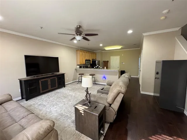 a kitchen with stainless steel appliances granite countertop a stove a sink dishwasher a refrigerator and a microwave