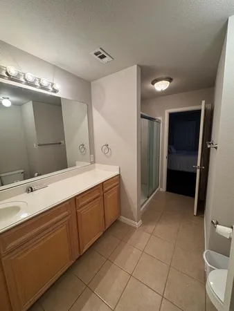 a bedroom with a bed window and a flat screen tv