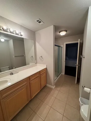 a bedroom with a bed window and a flat screen tv