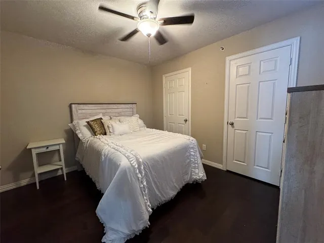 a view of bedroom with wooden floor