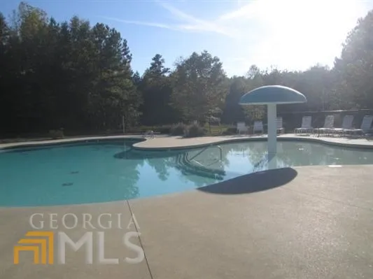 a view of a swimming pool with a yard