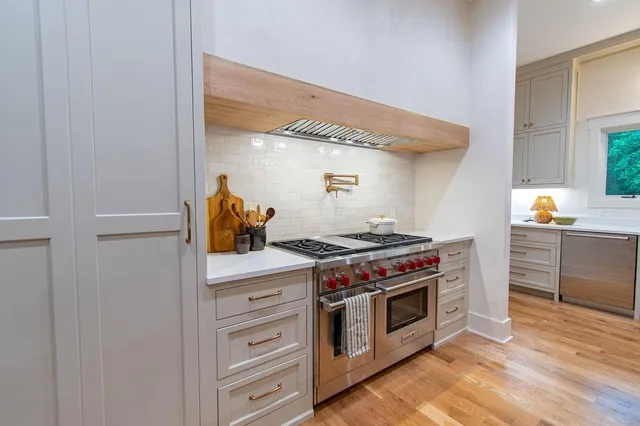 a room with a fireplace and a floor to ceiling window