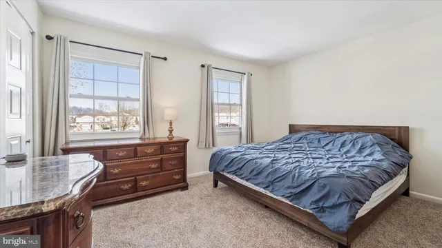 a spacious bedroom with a bed and window