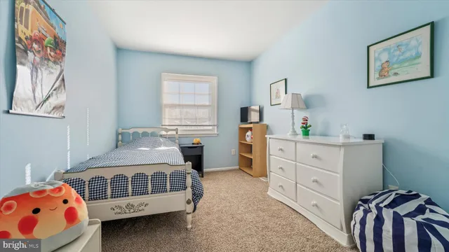 a bedroom with furniture and a window