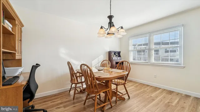 a view of a dining room with furniture wooden floor and chandelier