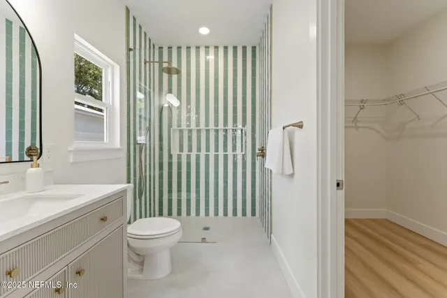 a bathroom with a toilet sink and mirror