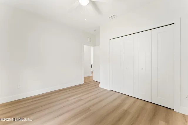 a bathroom with a toilet a sink a mirror a bathtub and vanity