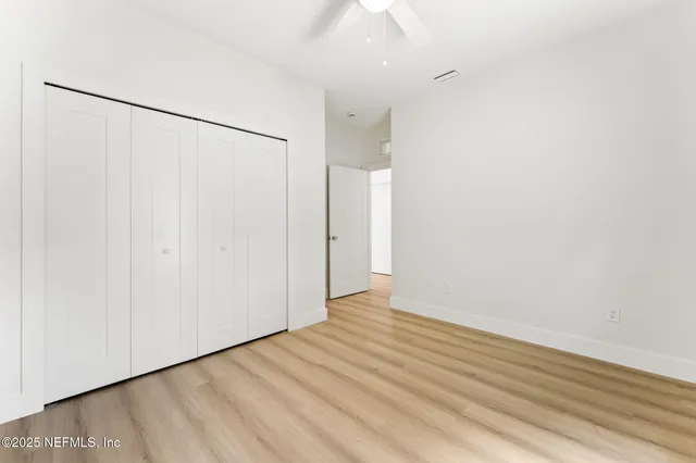 a view of a hallway with wooden shelves