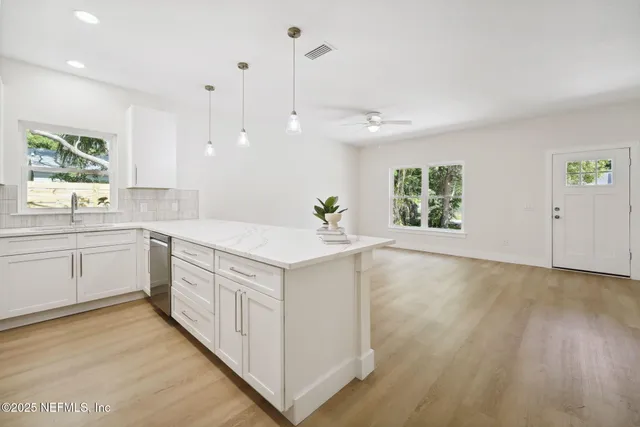a kitchen with a sink stove and microwave
