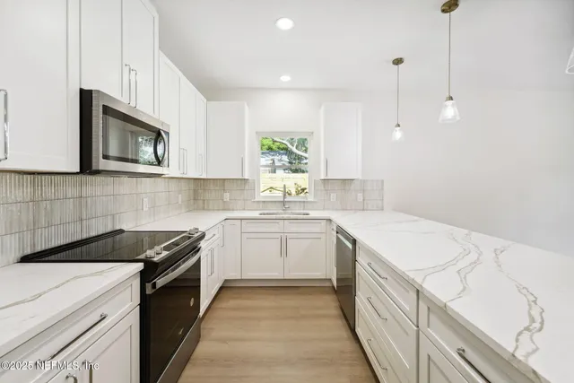 a kitchen with a white center island and windows