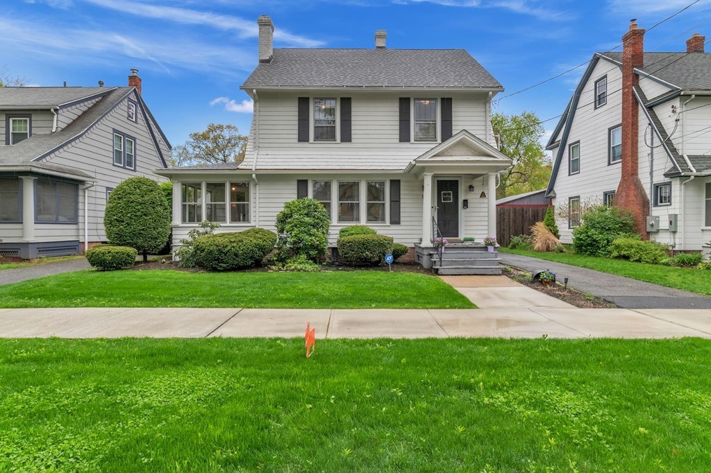 a front view of a house with a garden